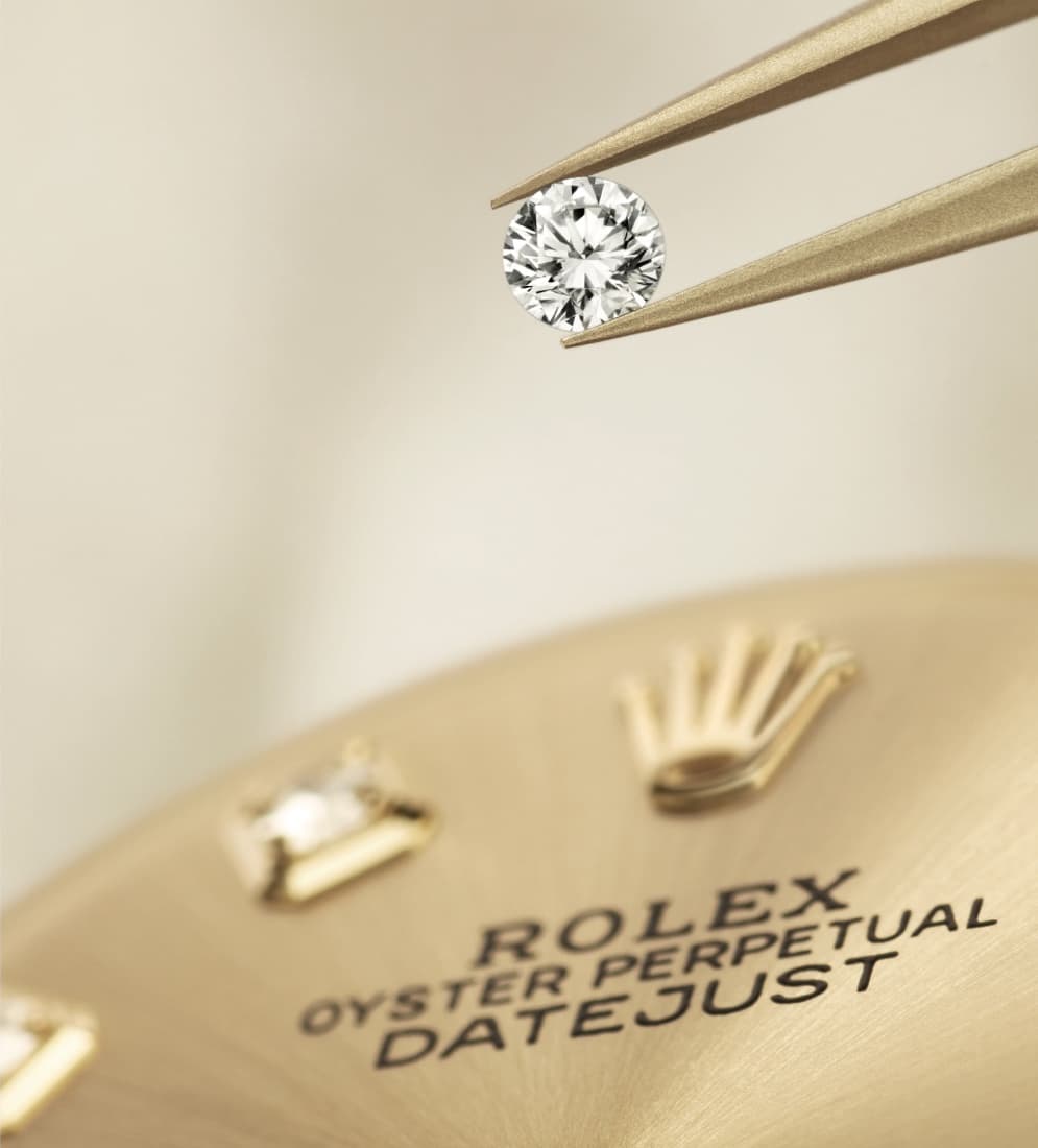 Diamond being placed on a Rolex Oyster Perpetual Datejust watch